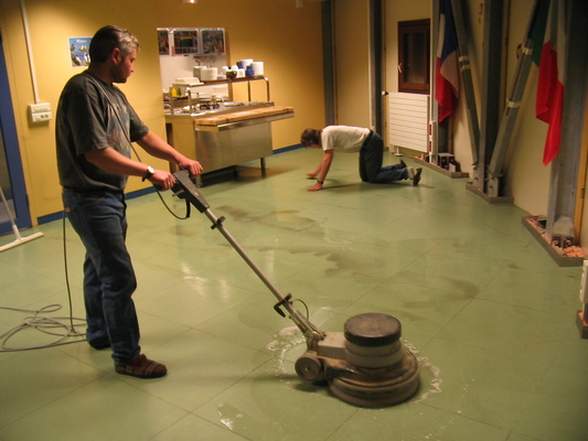 [20050706_005_NewFlooring.jpg]
Jean and Stef scrubbing the floor of the restaurant before applying a new layer of varnish.