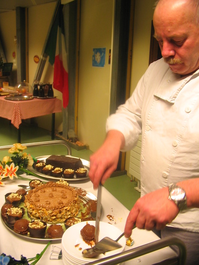 [20050813_069_ChocolateCake.jpg]
Jean-Louis gathering up the many different chocolate desserts into a plate.