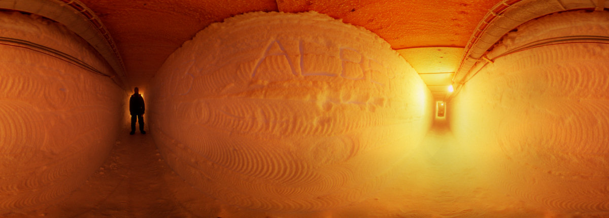 [IceTunnelOrangePano_.jpg]
The tunnel carved in snow and leading to the underground seismometers. First shot with the lights on. Notice the primitive pictographs left on the walls by the friendly locals.