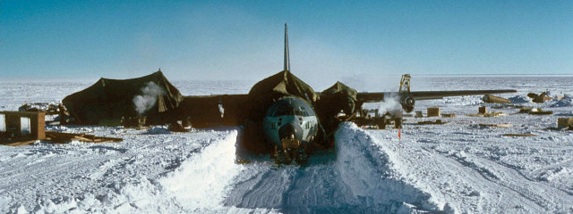 [Dome_Charlie_Slide01_.jpg]
A trench that had to be dug to reach around the aircraft after only a year on the high plateau. Notice the parachutes covering the plane where hot air is blown allowing the technicians to work in better conditions (image courtesy Richard Sheehan)