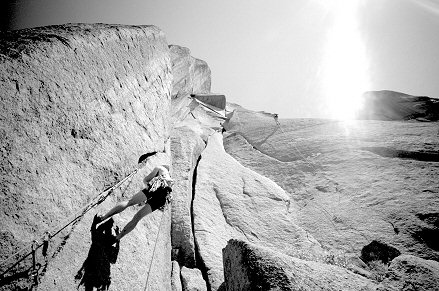 [WunschStart.jpg]
Climber hanging on the hard 5.12 start of Wunsch Dihedral (5.11) while Jenny is rappelling on the right.