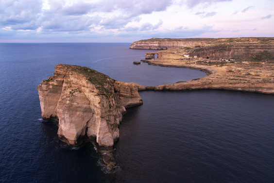 [20101030_181601_DwejraBay.jpg]
Dwejra Bay and the Azure Window in the back. Plenty of people walk on top, but when I swam under it I could see huge recent cracks in it. It probably won't stay standing for too much longer.