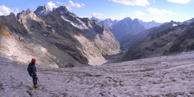 [20060906-1738-EtanconsGlacierPano_.jpg]
Coming down the Etançon glacier with still a long way to go down the Etançon valley until reaching the tiny outpost of La Bérarde. We got there at 21:00, hungry and without a ride back to the car. We were lucky to (1) find a restaurant still open and (2) figure out that the waiter was riding back in the same direction as ourselves 15 minutes later. The entire village is actually off limits 6 months a year due to avalanches on the road. The summits on the left are the Pavé (3823m), Grande Ruine (3765m) and Pic Nord des Cavales (3362m).