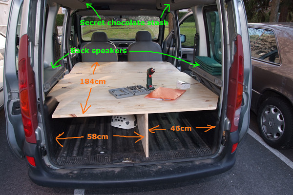 [20071125_152317_Kangoo.jpg]
Same view as the first, with the front seats folded forward and the front board unfolded: the bed is ready. Because of the position of the grooves on the ground of the car, the central support board is not right in the center, which is actually a good thing if you need to carry a large box or suitcase. At 184x130cm, the bed is actually quite spacious for two and can probably accommodate an extra child although that's none of my concern. Remember to keep the side windows open and never, ever, sleep with the engine on even if dead cold. Carbon monoxide poisoning is painless they say, but that doesn't make it nice.