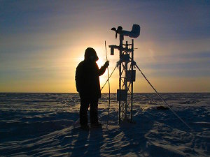 Emanuele measuring the height above ground of the old Automated Weather Station