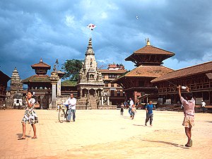 Kids playing with a kite near old temples