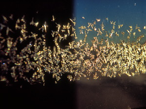 Thin frost on a window, illuminated by the midnight sun