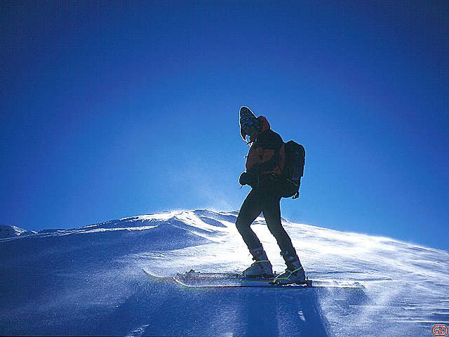 [SkiWind.jpg]
A nice image, but poorly scanned. Wind was blowing snow crystals down the slope of a remote Appennine peak, shining in the back light.